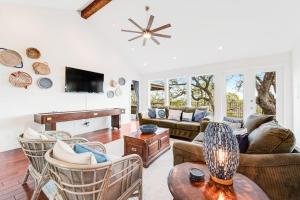 a living room with a couch and a piano at Natural Cliffside Oasis with Impressive Views, Gas Fireplace and Dock in Spicewood