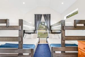 two bunk beds in a room with a window at Natural Cliffside Oasis with Impressive Views, Gas Fireplace and Dock in Spicewood +32 photos