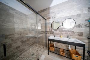 a bathroom with a sink and a shower at Hostal ZENTRAL in Alora +37 photos
