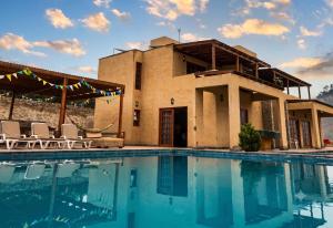 a house with a swimming pool in front of it at Cieneguilla Eco House in Cieneguilla