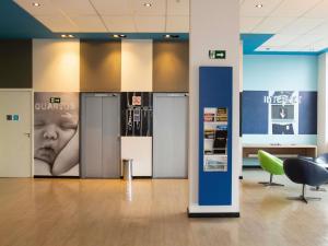 a lobby with two elevators in a building at ibis budget Manhuaçu in Manhuaçu