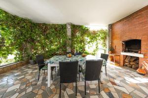 a patio with a table and chairs and a brick wall at Ilma Apartment in Trogir