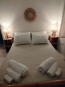 a bedroom with a bed with towels on it at Captain's House in Filiatra