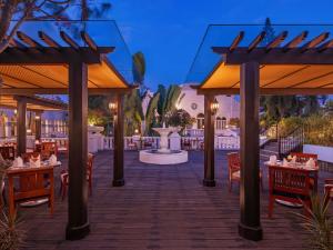 a rendering of a restaurant with tables and chairs at Hotel Majapahit Surabaya MGallery in Surabaya
