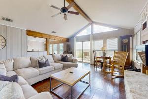 a living room with a couch and a table at Spacious Lakefront Hideaway with Decks, Grill, Billiards, Tennis & Pool in Spicewood