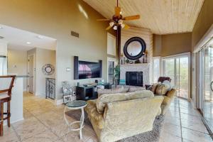 a living room with a couch and a fireplace at Refined Panoramic Paradise on Lake Travis with Boat Launch and Tesla Charger in Spicewood