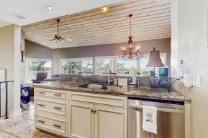 a kitchen with a sink and a counter top at Refined Panoramic Paradise on Lake Travis with Boat Launch and Tesla Charger in Spicewood