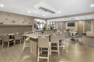 a restaurant with tables and chairs in a cafeteria at Best Western Plus Spokane North in Spokane