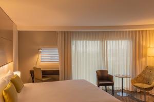 a hotel room with a bed and a desk at Point Hotel in Brisbane