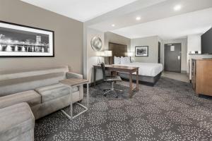 a hotel room with a bed and a desk at Best Western Plus Spokane North in Spokane