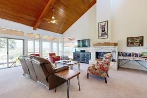 a living room with a couch and chairs and a fireplace at Regal Riverfront Home with 2 Cabins - 2 Miles to Marina in Spicewood