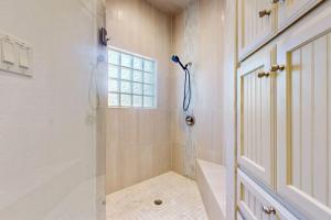 a bathroom with a shower and a window at Regal Riverfront Home with 2 Cabins - 2 Miles to Marina in Spicewood +35 photos