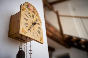 an old clock hanging on a wall at Vila Dobra in Dobravlje +17 photos