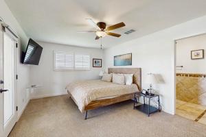 a bedroom with a bed and a ceiling fan at Waterfront Home with Kayaks, Game Room, Firepit, & Enormous Deck in Kingsland