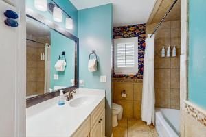 a bathroom with a sink and a tub and a toilet at Waterfront Home with Kayaks, Game Room, Firepit, & Enormous Deck in Kingsland +17 photos