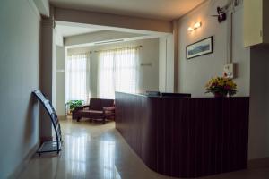 a hospital lobby with a reception desk and a chair at Hotel Ariel in Kohīma