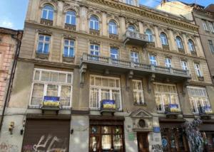 a large stone building with windows and a balcony at Svit home Hamster 007- apart-hotel in Lviv