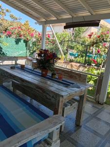 a wooden picnic table with two potted plants on it at Dal urla in Urla
