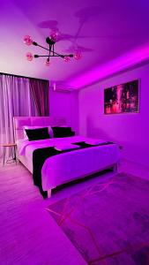 a purple bedroom with two beds and a purple ceiling at Escapist Apartments in Niš