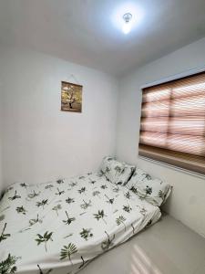 a small bedroom with a bed in a room at Home Vacation in Ormoc City in Catmon