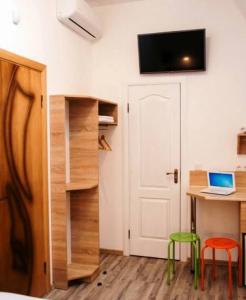 a room with a desk and a laptop on a table at Svit home Hamster 007- apart-hotel in Lviv