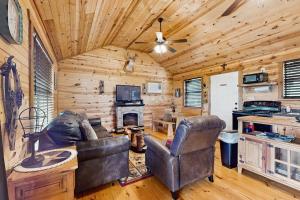 a living room with a couch and a fireplace at Dog-Friendly Gem on 11 Acres with Valley Views, Deck, Gas Grill, Fireplace in Fredericksburg