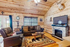 a living room with a couch and a fireplace at Dog-Friendly Gem on 11 Acres with Valley Views, Deck, Gas Grill, Fireplace in Fredericksburg