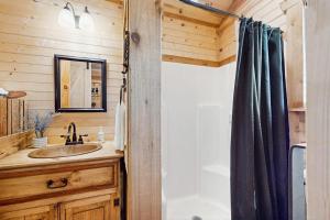 a bathroom with a sink and a shower at Dog-Friendly Gem on 11 Acres with Valley Views, Deck, Gas Grill, Fireplace in Fredericksburg +9 photos