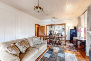 a living room with a couch and a dining room at Enchanting Home with Fireplace, Full Kitchen, Patio, Central AC, & Washer/Dryer in Fredericksburg