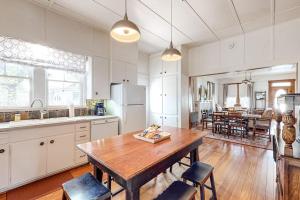 a kitchen with a wooden table and a dining room at Enchanting Home with Fireplace, Full Kitchen, Patio, Central AC, & Washer/Dryer in Fredericksburg
