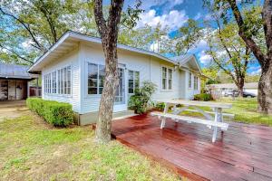 a white house with a picnic table in front of it at Enchanting Home with Fireplace, Full Kitchen, Patio, Central AC, & Washer/Dryer in Fredericksburg
