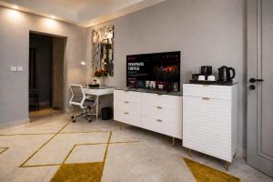 a room with a desk and a table with a chair at The Alima Suites in Accra