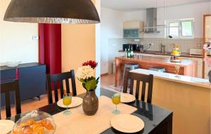 a kitchen with a table with a vase of flowers at Gorgeous Home In Solin in Solin