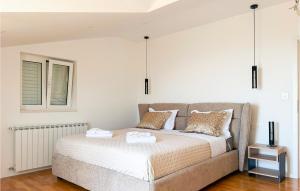a bedroom with a bed with two towels on it at Gorgeous Home In Solin in Solin