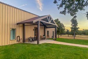 a pavilion with a table and chairs next to a building at Expansive Getaway Near Downtown with Fast WiFi, Grill in Fredericksburg