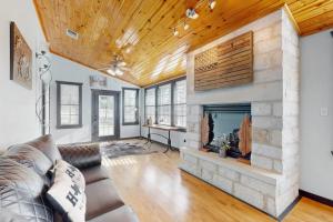 a living room with a couch and a fireplace at Ranch Home with Hot Tub on 7 Secluded Acres - Minutes to Downtown Fredericksburg in Fredericksburg