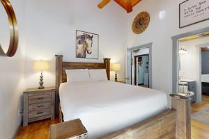 a bedroom with a bed and a clock on the wall at Ranch Home with Hot Tub on 7 Secluded Acres - Minutes to Downtown Fredericksburg in Fredericksburg