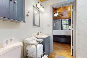 a bathroom with a sink and a bathroom with a bed at Ranch Home with Hot Tub on 7 Secluded Acres - Minutes to Downtown Fredericksburg in Fredericksburg +16 photos
