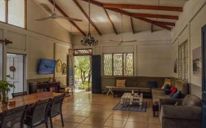 a living room with a couch and a table at Hostel Nosara in Playa Guiones