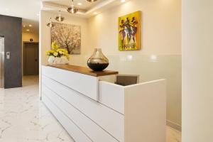 a lobby with a vase on a counter at The Alima Suites in Accra