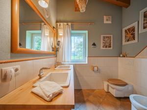 a bathroom with two sinks and a toilet at Panoramahaus Itter in Itter +21 photos