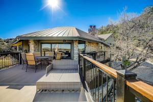 a house with a deck with a table and chairs at Stunning Lakefront Home with 2 Patios, Chef's Kitchen, & Lake Access in Spicewood