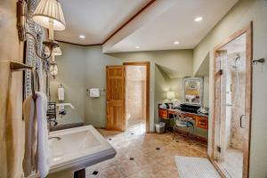 a bathroom with a tub and a sink at Stunning Lakefront Home with 2 Patios, Chef's Kitchen, & Lake Access in Spicewood +51 photos
