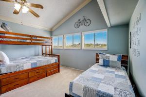 a bedroom with two beds and a bicycle on the wall at Stunning Lakefront Home with 2 Patios, Chef's Kitchen, & Lake Access in Spicewood