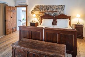 a bedroom with a large wooden bed with white pillows at Vila Dobra in Dobravlje