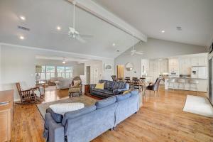 a living room with a blue couch and a kitchen at Lakeside, Dog-Friendly Living with Kayaks, Boat Ramp, Pool Table & Ping-Pong in Kingsland