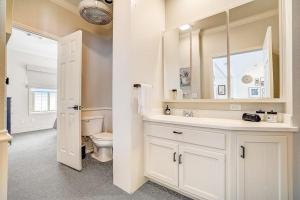 a white bathroom with a toilet and a sink at Lakeside, Dog-Friendly Living with Kayaks, Boat Ramp, Pool Table & Ping-Pong in Kingsland +40 photos