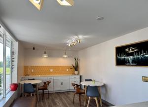 a kitchen with two tables and chairs at ROYALINN in Elizabethtown