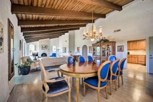 a dining room with a wooden table and blue chairs at Snowbird-Friendly House with Game Room, Full Kitchen, Balcony & W/D in Kerrville