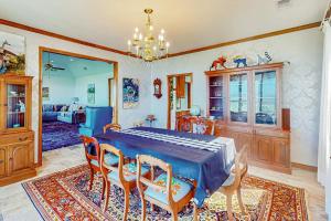 a dining room with a blue table and chairs at 2-Story Home with Covered Patio, Balcony, Fireplace, Streaming, Great Views, W/D in Kerrville